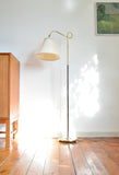 Interior picture of Art deco floor lamp in brass and browned brass with original shade