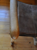 Detail of Classic folding chairs in oak and leather upholstery