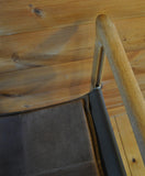 Detail of Classic folding chairs in oak and leather upholstery