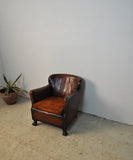 Club chair with original leather from 1920s