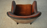 Club chair with original leather from 1920s