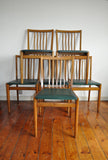 6 danish dining chairs. Oak and dark green artificial leather.