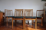 6 danish dining chairs. Oak and dark green artificial leather.