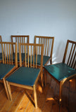 6 danish dining chairs. Oak and dark green artificial leather.